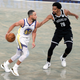 Stephen Curry #30 of the Golden State Warriors dribbles against Spencer Dinwiddie #26 of the Brooklyn Nets during the first half at Barclays Center on December 22, 2020 in the Brooklyn borough of New York City.